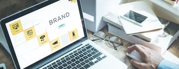 Laptop displaying brand strategy elements and icons, symbolising Amazon Brand Registry and vendor brand management.